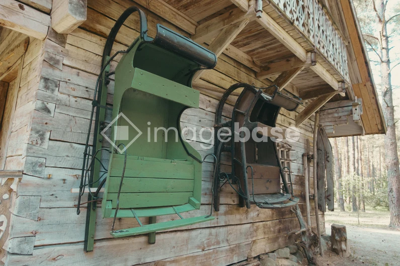 Rustic Sleighs on Wooden Cabin