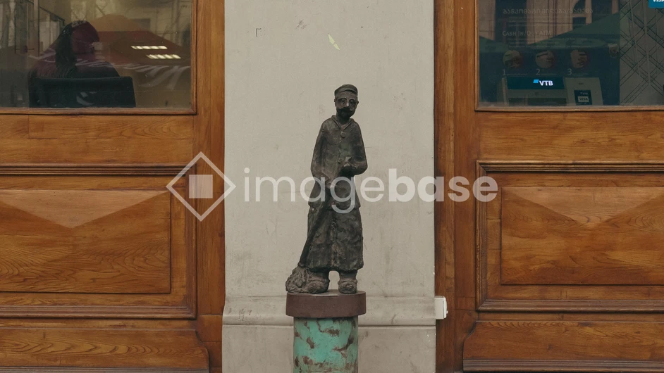 Statue by Wooden Doors