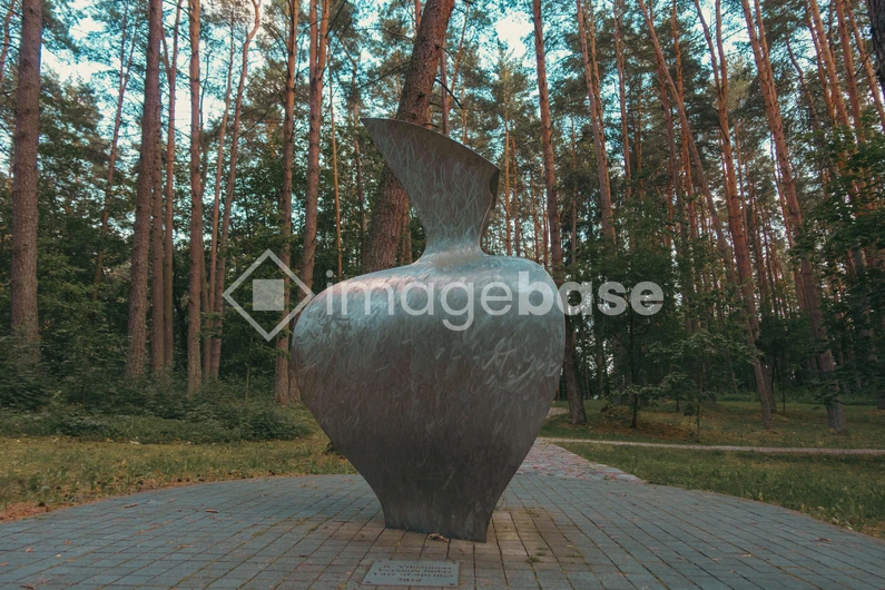 Metallic Sculpture in Forested Park