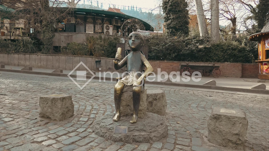 Statue on a Cobblestone Street