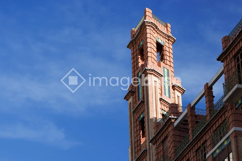 Architectural Brick Tower Against Blue Sky