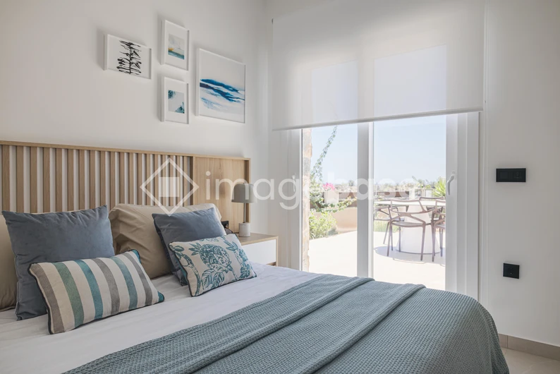 Cozy Bedroom with Balcony View