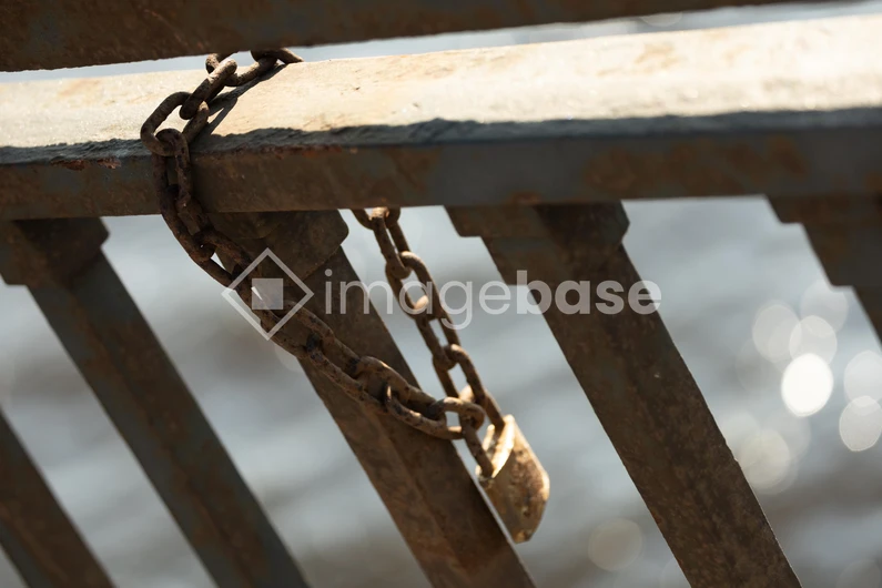 Weathered Lock on Metal Rail