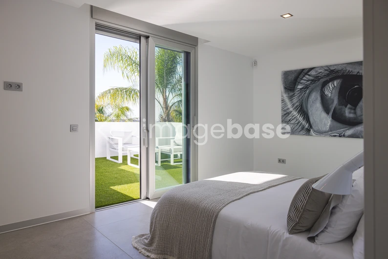 Modern Bedroom with Balcony View