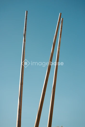 Tall Poles Against Blue Sky