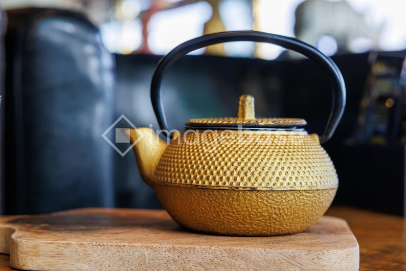 Golden Teapot on Wooden Surface