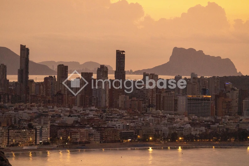 Sunset Over a Coastal City Skyline