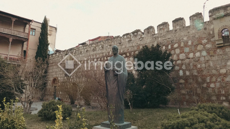 Historical Statue and Ancient Wall