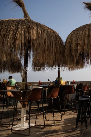 Seaside Lounge with Straw Umbrellas