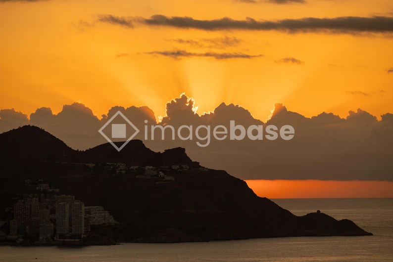 Sunset Over Mountainous Coastline