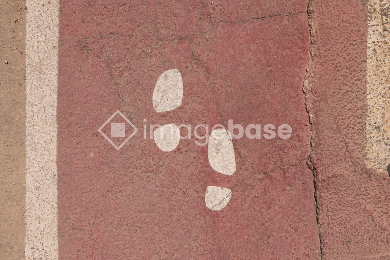 Footprint Path on Red Pavement