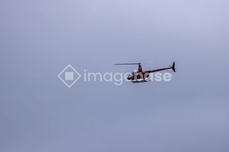 Helicopter Against a Cloudy Sky